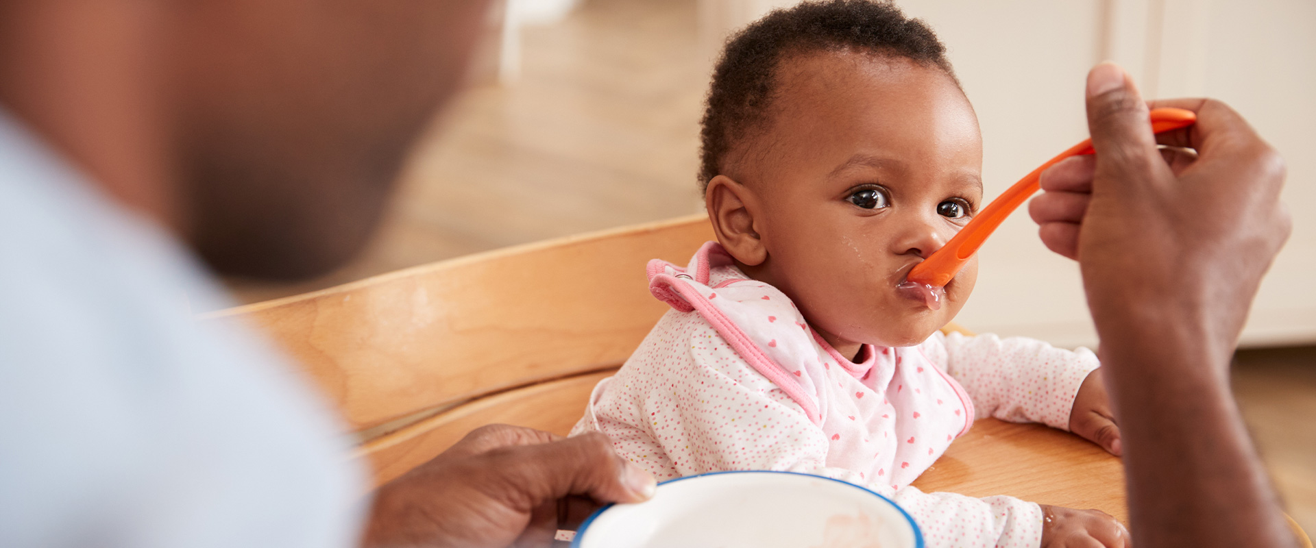 Daddy feeding baby