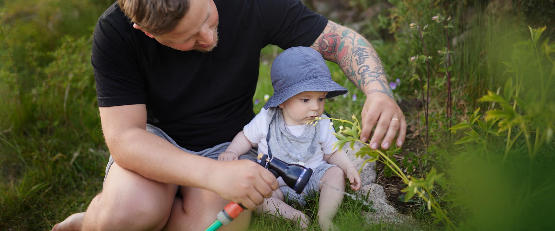 Baby and father in garden