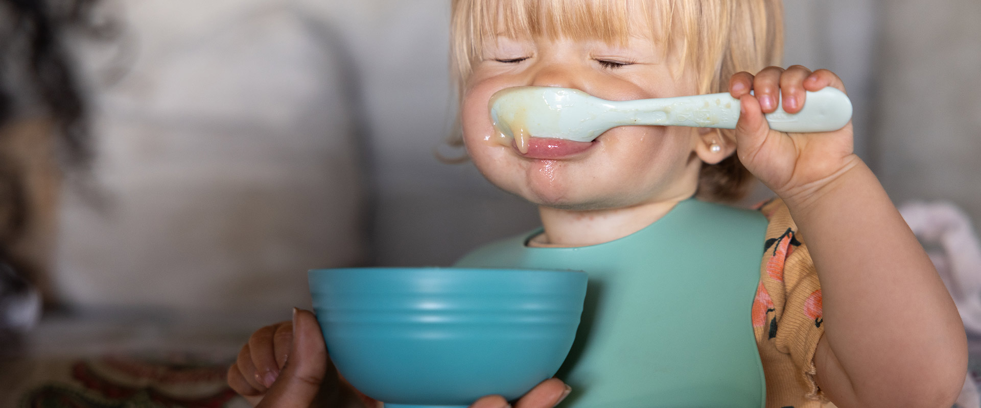 Baby eating with closed eyes