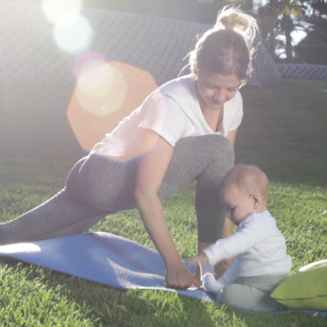 Woman doing yoga with baby